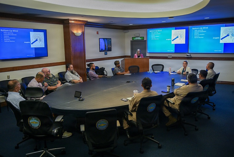 Several people sitting around a conference table